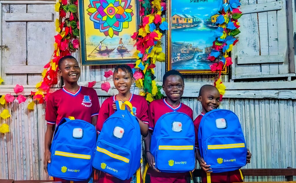 Child studying with a solar school bag at Makoko Dream School