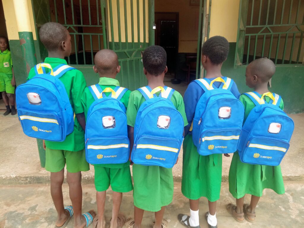 Rural children using solar school bags for clean energy education 